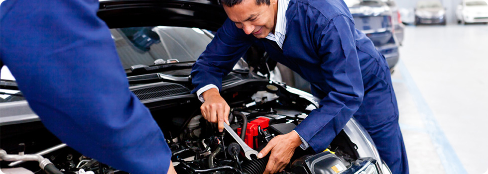 automotive technicians working on car